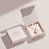 Gold heart-shaped necklace in a 'ANIA HAE' box on a light background