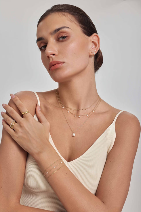 Gold Dangling Bead Station Necklace